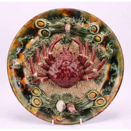 25 - Ceramics - a 19th century Portuguese Palissy ware plate, depicting a crab on a sedimentary sea floor... 