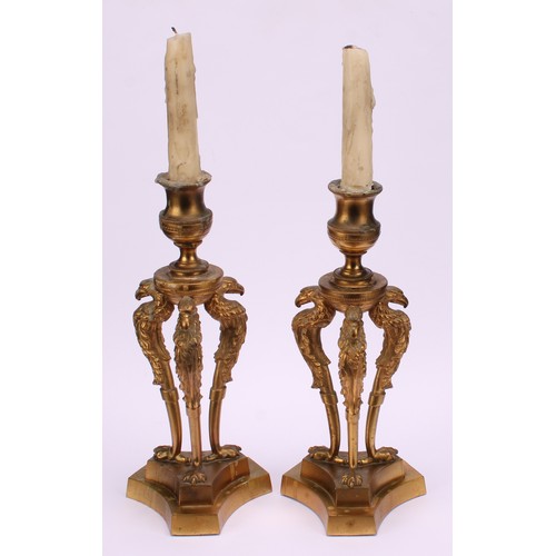 1290 - A pair of 19th century gilt bronze triform mantel candlesticks, campana sconces, griffin monopodia, ... 