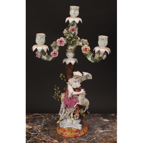 141 - A pair of 19th century German porcelain figural four-light, three-branch candelabra, as a shepherd a... 