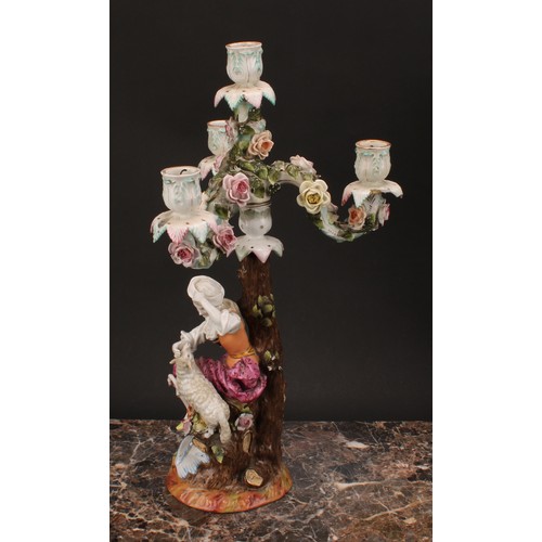 141 - A pair of 19th century German porcelain figural four-light, three-branch candelabra, as a shepherd a... 