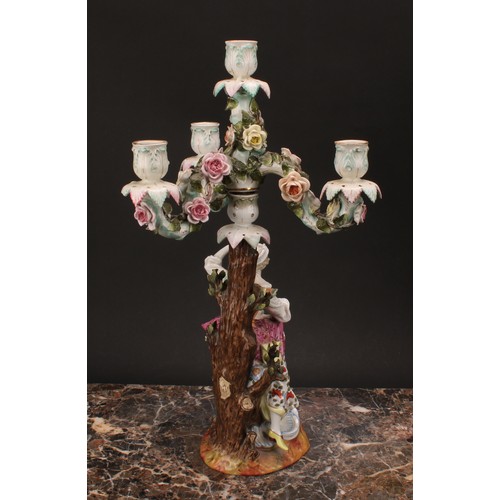 141 - A pair of 19th century German porcelain figural four-light, three-branch candelabra, as a shepherd a... 