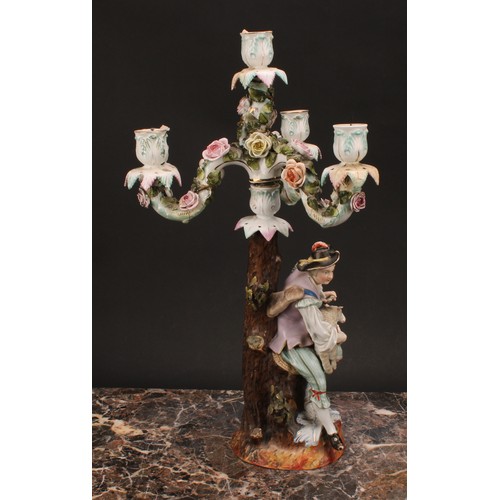 141 - A pair of 19th century German porcelain figural four-light, three-branch candelabra, as a shepherd a... 