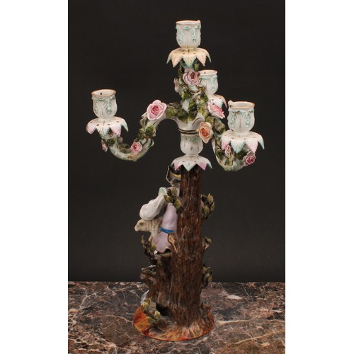 141 - A pair of 19th century German porcelain figural four-light, three-branch candelabra, as a shepherd a... 