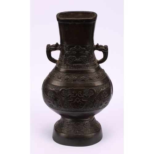 213 - A Chinese bronze hu vase, cast in the Archaic taste with taotie, prunus and waves, 25cm high, 19th c... 