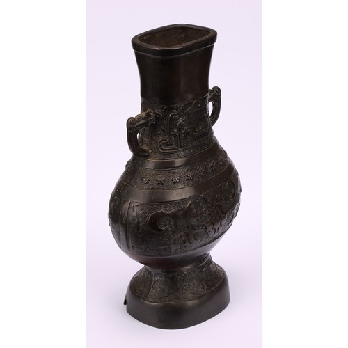 213 - A Chinese bronze hu vase, cast in the Archaic taste with taotie, prunus and waves, 25cm high, 19th c... 