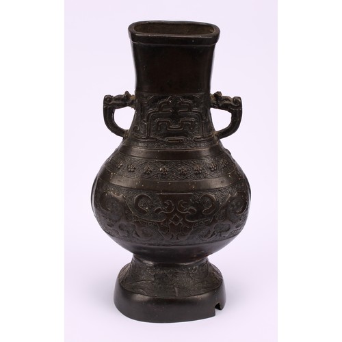 213 - A Chinese bronze hu vase, cast in the Archaic taste with taotie, prunus and waves, 25cm high, 19th c... 