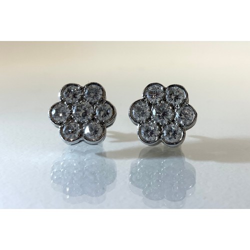 948 - A pair of diamond floral cluster earrings, each set with seven round brilliant cut diamonds, total e... 