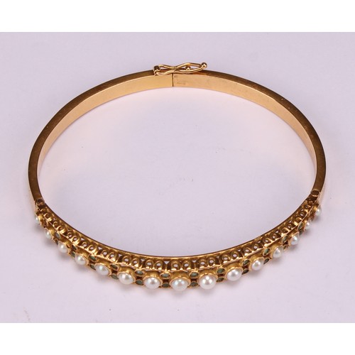 957 - An 18ct gold hinged bangle, set with 15 graduated pearls, each flanked and divided by pairs of small... 