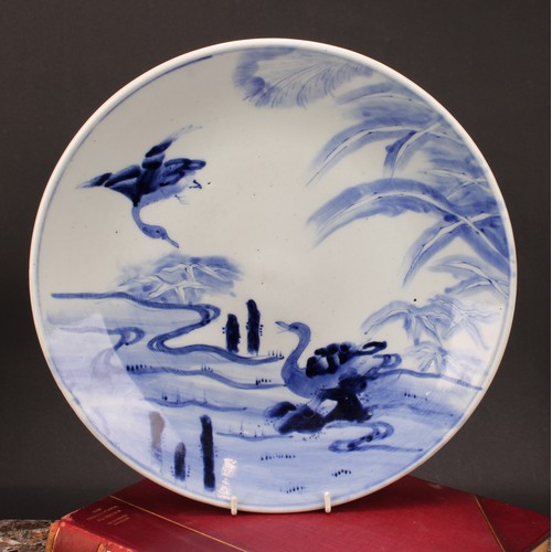 234 - A Japanese Meiji blue and white charger, painted with pair of geese, one in flight the other nesting... 