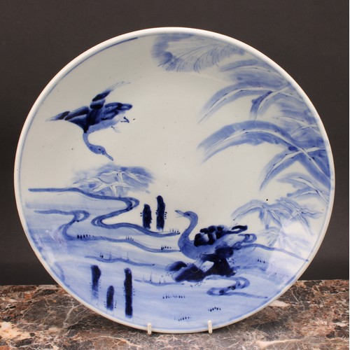 234 - A Japanese Meiji blue and white charger, painted with pair of geese, one in flight the other nesting... 