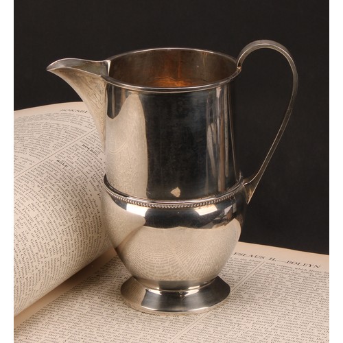 660 - A George V silver footed cream jug, beaded band, 16cm high, Birmingham 1933, 290g