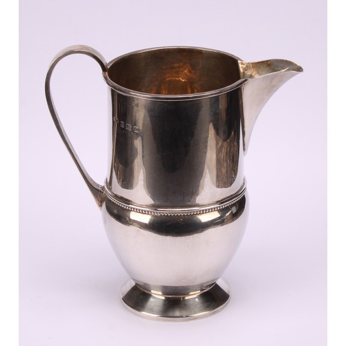 660 - A George V silver footed cream jug, beaded band, 16cm high, Birmingham 1933, 290g