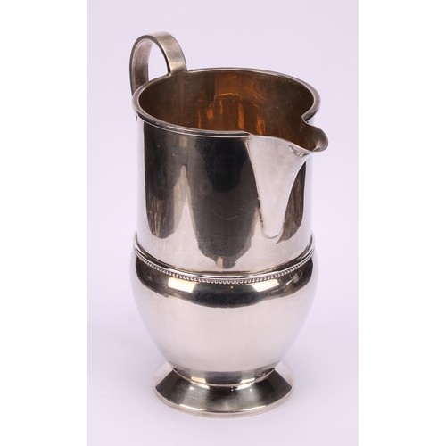 660 - A George V silver footed cream jug, beaded band, 16cm high, Birmingham 1933, 290g