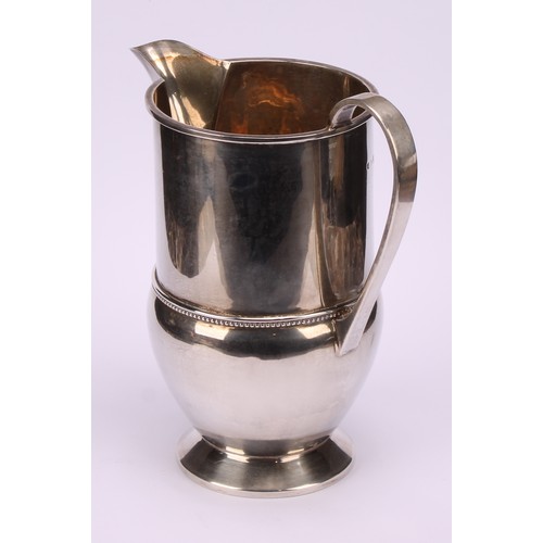 660 - A George V silver footed cream jug, beaded band, 16cm high, Birmingham 1933, 290g