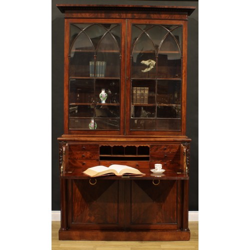 1329 - A George IV mahogany secretaire bookcase, gadrooned cornice above a pair of astragal glazed doors wi... 