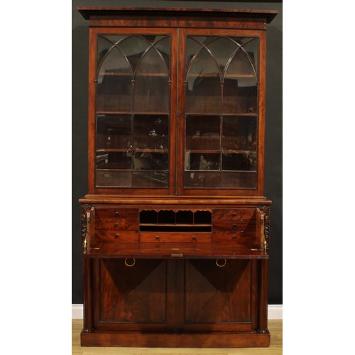 1329 - A George IV mahogany secretaire bookcase, gadrooned cornice above a pair of astragal glazed doors wi... 