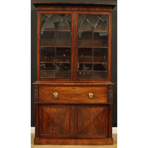 1329 - A George IV mahogany secretaire bookcase, gadrooned cornice above a pair of astragal glazed doors wi... 