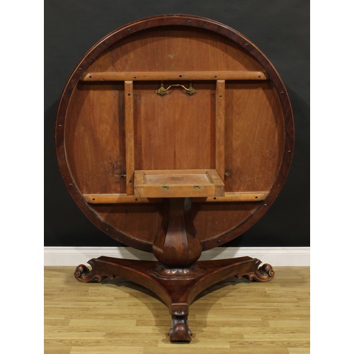 1352 - A Victorian mahogany centre table, circular tilting top with moulded edge, panelled baluster column,... 