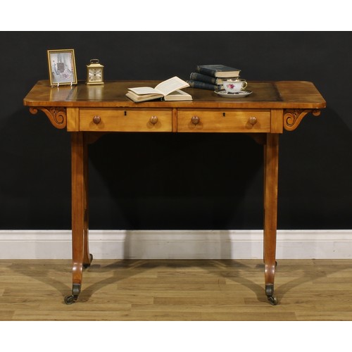 1208 - A George IV walnut writing table, rounded rectangular top with inset tooled and gilt writing surface... 