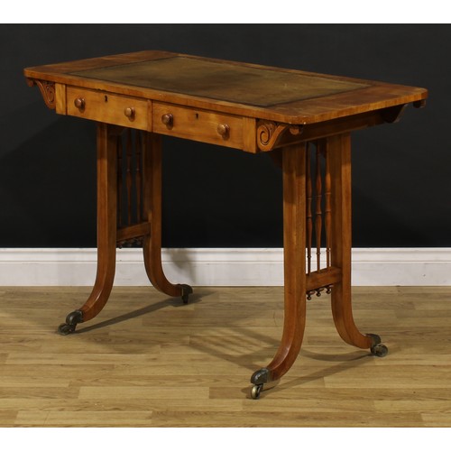 1208 - A George IV walnut writing table, rounded rectangular top with inset tooled and gilt writing surface... 