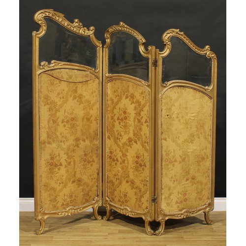 1431 - A Rococo design giltwood three fold screen, each panel with bevelled glass plate above a silk panel ... 