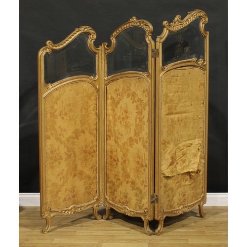 1431 - A Rococo design giltwood three fold screen, each panel with bevelled glass plate above a silk panel ... 