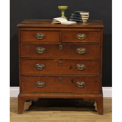 1190 - A George III oak chest, of two short and three long graduated drawers, brass swing handles, skirted ... 