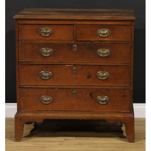 1190 - A George III oak chest, of two short and three long graduated drawers, brass swing handles, skirted ... 