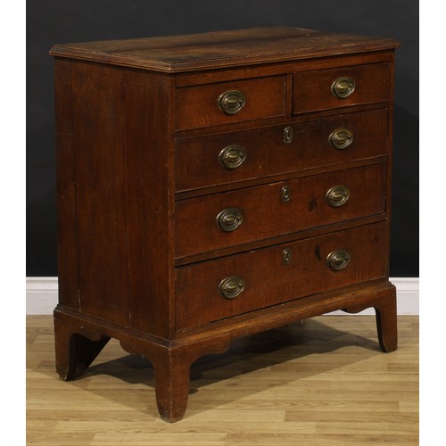 1190 - A George III oak chest, of two short and three long graduated drawers, brass swing handles, skirted ... 