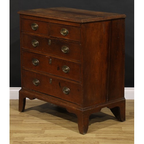 1190 - A George III oak chest, of two short and three long graduated drawers, brass swing handles, skirted ... 