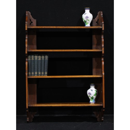 1337 - A late Victorian Aesthetic Movement walnut wall-hanging bookcase or display shelves, by or retailed ... 