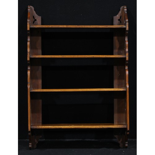 1337 - A late Victorian Aesthetic Movement walnut wall-hanging bookcase or display shelves, by or retailed ... 