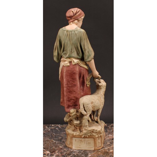 156 - A Royal Dux figure, of a Shepherdess, standing with blossom in her apron, a sheep by her side, in sh... 