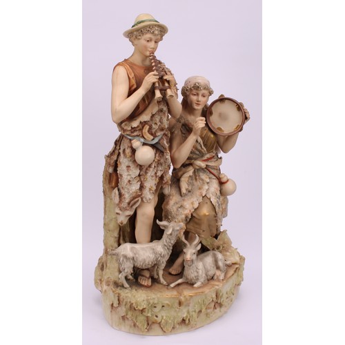 154 - A Royal Dux figure group, modelled with shepherd and shepherdess musicians, he with pipes, her seate... 