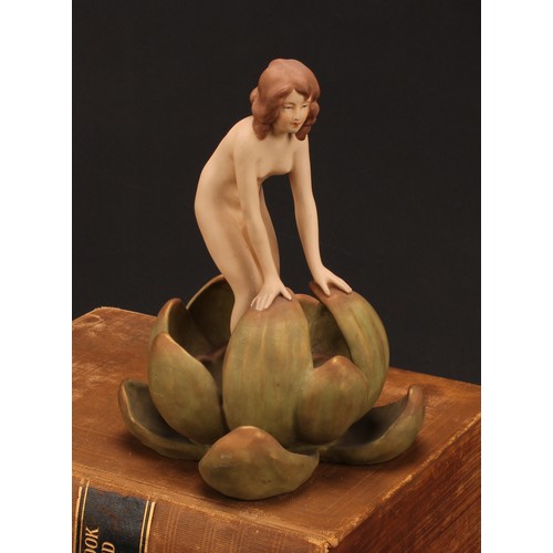 159 - An Art Nouveau Royal Dux figure, of a female nude emerging from a water lily, in shot enamels and gi... 