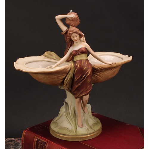 160 - An Art Nouveau Royal Dux table centrepiece, modelled as two maidens seated and standing beside two o... 