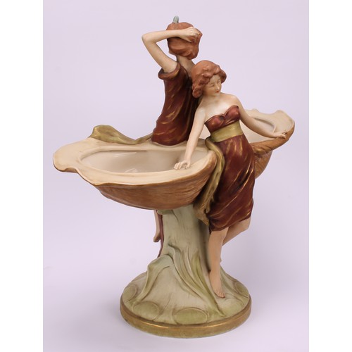 160 - An Art Nouveau Royal Dux table centrepiece, modelled as two maidens seated and standing beside two o... 