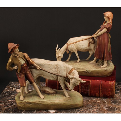 149 - A pair of Royal Dux figures, of boy and girl farmhands, he with a bullock, she with a goat, in shot ... 