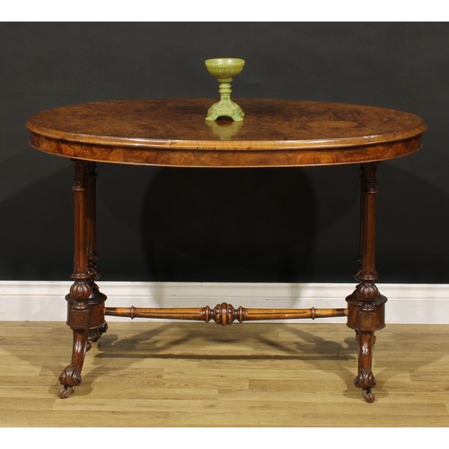 1448 - A Victorian walnut oval centre table, moulded top with matched veneers, turned and fluted supports a... 