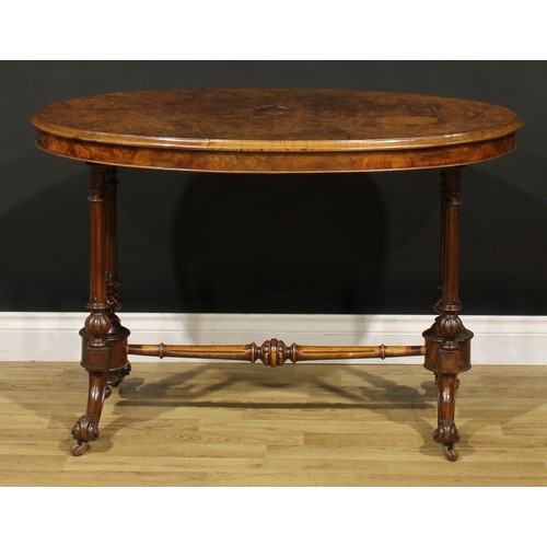 1448 - A Victorian walnut oval centre table, moulded top with matched veneers, turned and fluted supports a... 