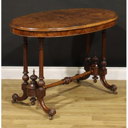 1448 - A Victorian walnut oval centre table, moulded top with matched veneers, turned and fluted supports a... 