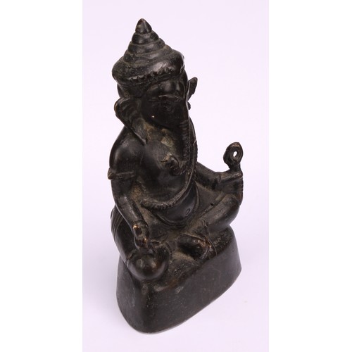 261 - Indian School, a dark patinated bronze, Ganesh, 15cm high