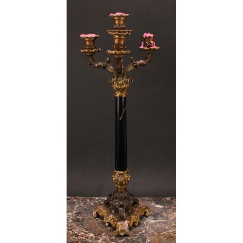 1289 - A pair of 19th century gilt and dark patinated bronze, and black marble four-light table candelabra,... 