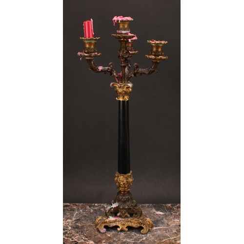 1289 - A pair of 19th century gilt and dark patinated bronze, and black marble four-light table candelabra,... 