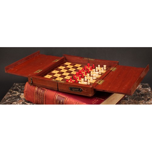 1917 - An early 20th century mahogany travelling chess set, by Hamleys, London, turned bone pieces with red... 