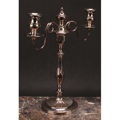 552 - A pair of George III Old Sheffield Plate two-light table candelabra, campana sconces, slender balust... 