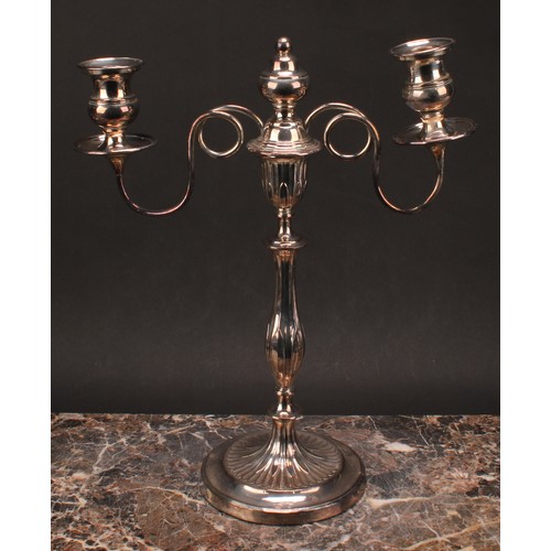 552 - A pair of George III Old Sheffield Plate two-light table candelabra, campana sconces, slender balust... 