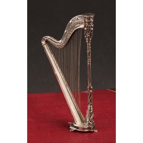 603 - A Continental cast silver miniature model, of a harp, 15.5cm high, import marks for London 1990, 114... 