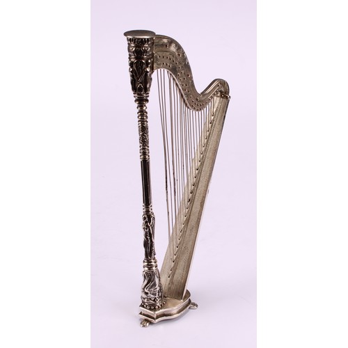 603 - A Continental cast silver miniature model, of a harp, 15.5cm high, import marks for London 1990, 114... 