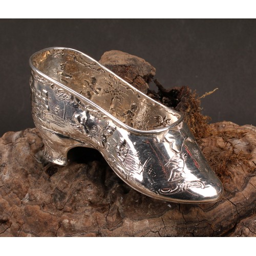 613 - A Dutch silver novelty vessel, as a shoe, chased with putti, 12cm long, import marks for London 1903... 